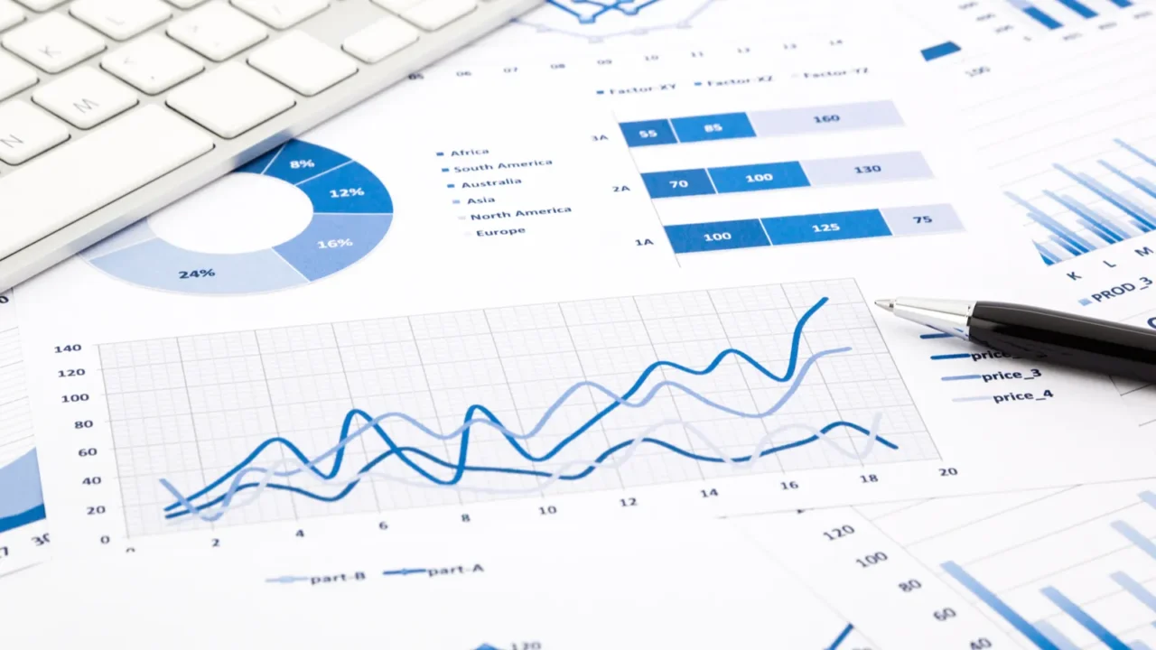 blue graph and chart reports on office table