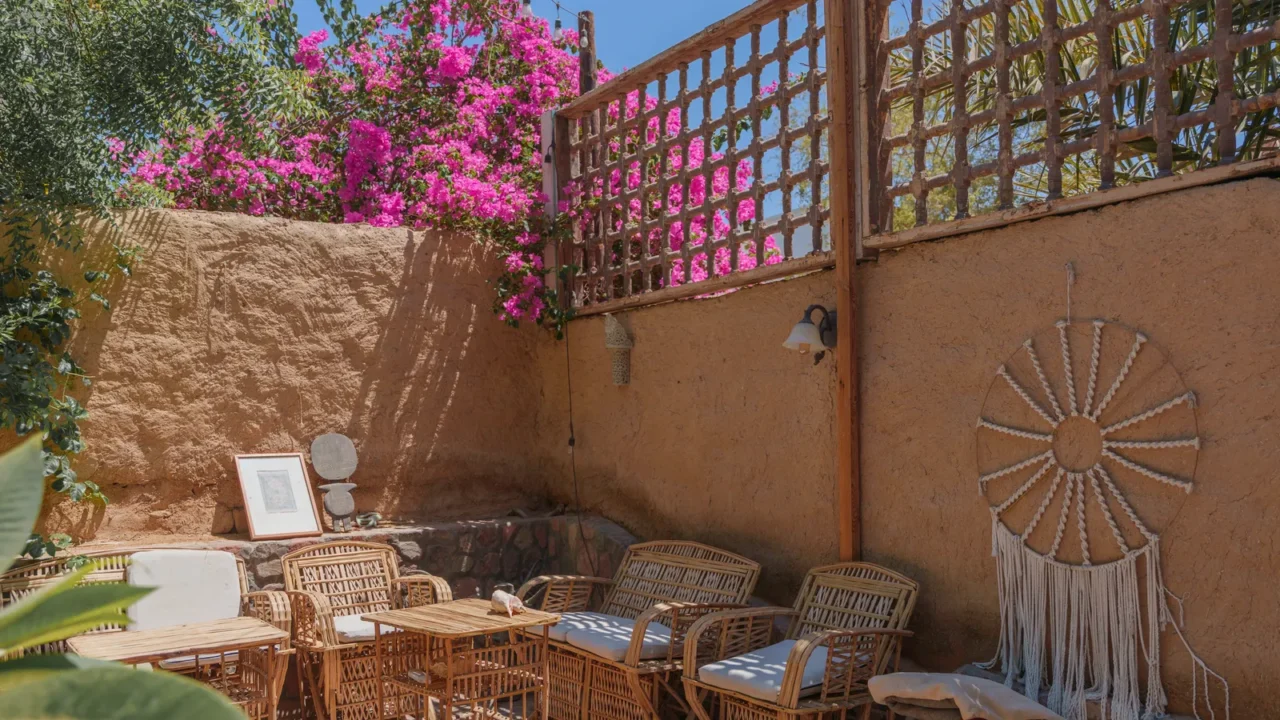 bohemian outdoor patio with wicker furniture and bougainvilea in sunny