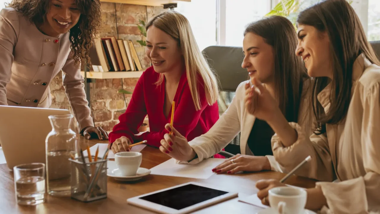 business young caucasian woman in modern office with team