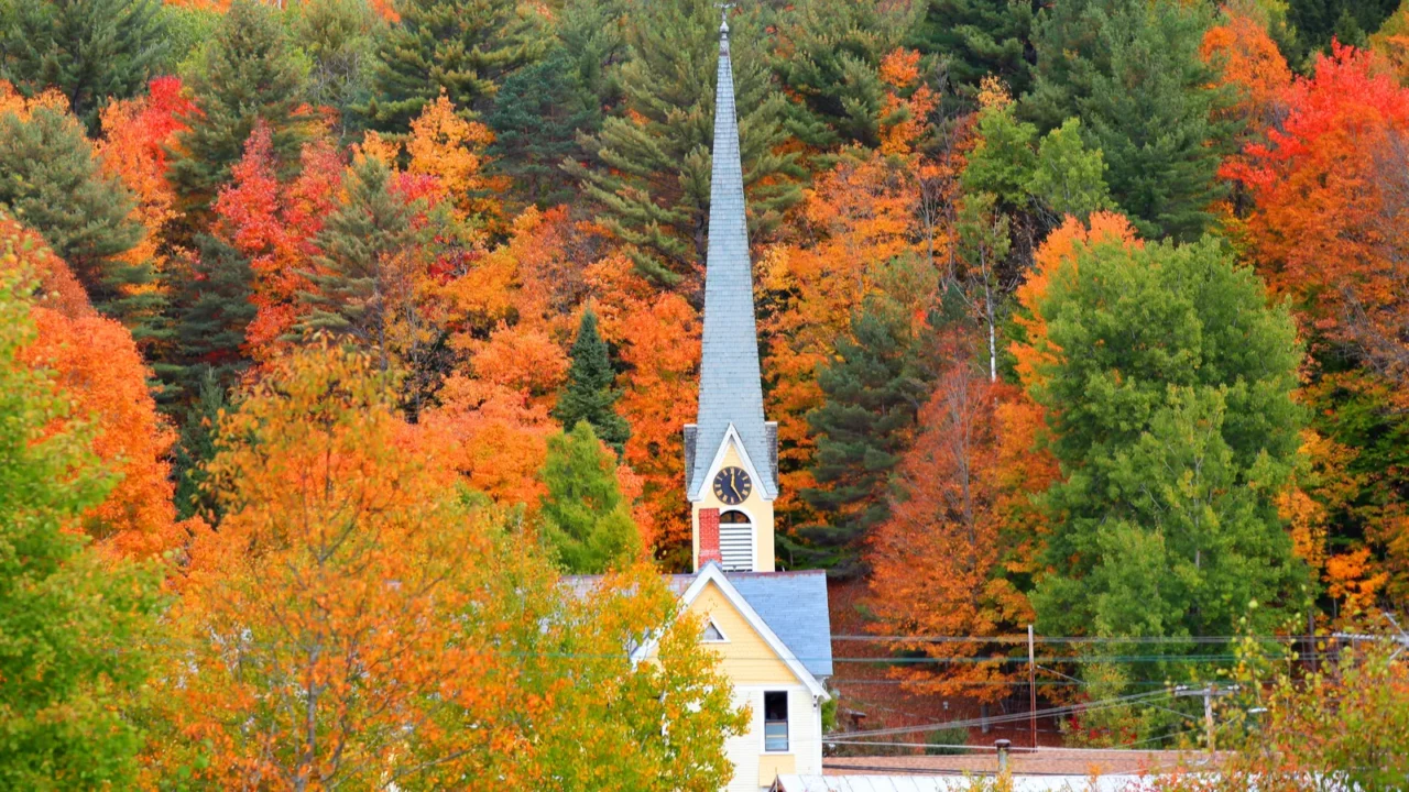 church steeple between autumn trees in east royalton vermont