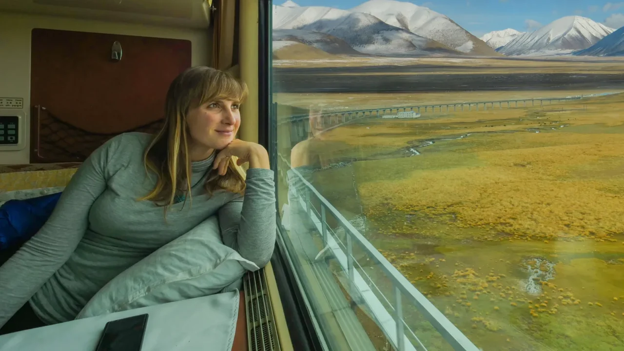close up smiling woman looks at the landscape while riding