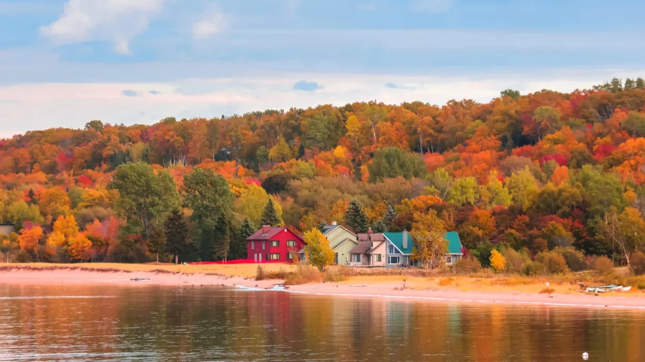 colorful homes at the lake superior shore surrounded by fall