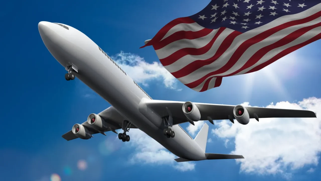 composition of airplane flying against american flag and sky united