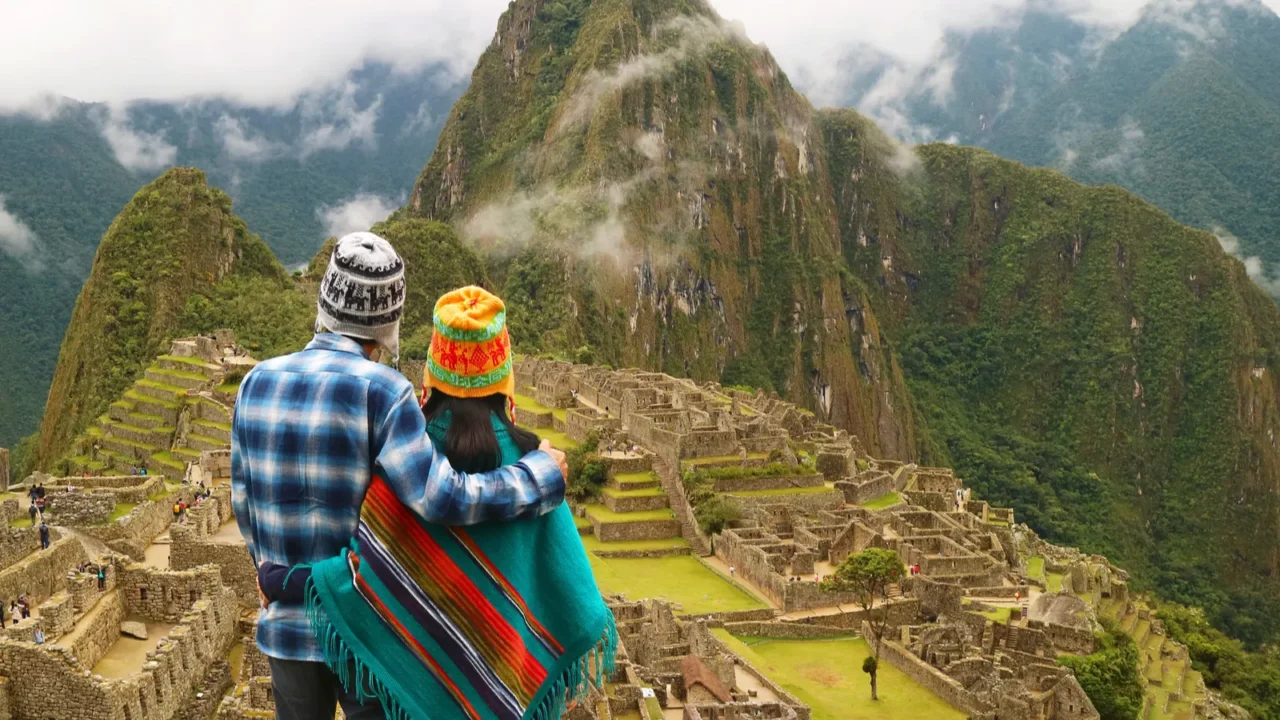 couple being impressed with the incredible view of machu picchu