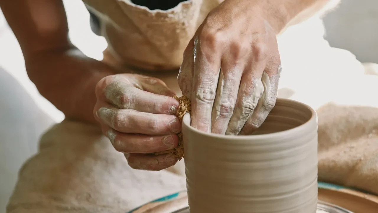 cropped image of male craftsman working on potters wheel at