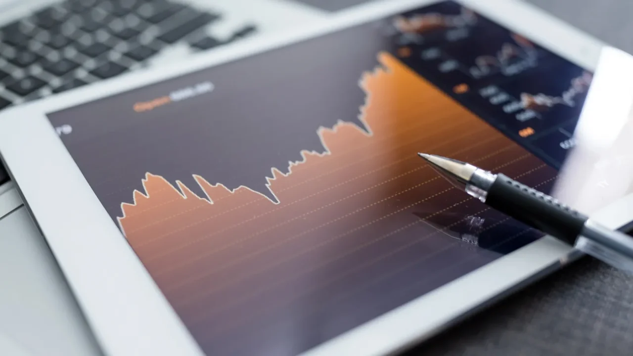 digital tablet with business charts on a screen