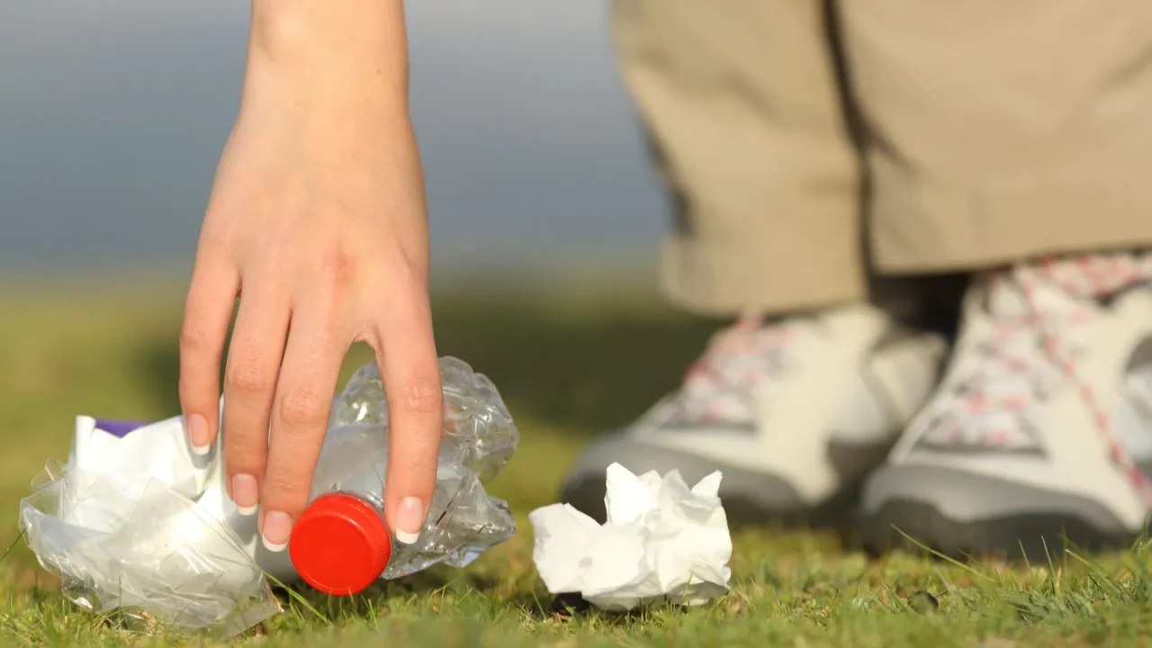 eco hiker hand collecting garbage in the mountain