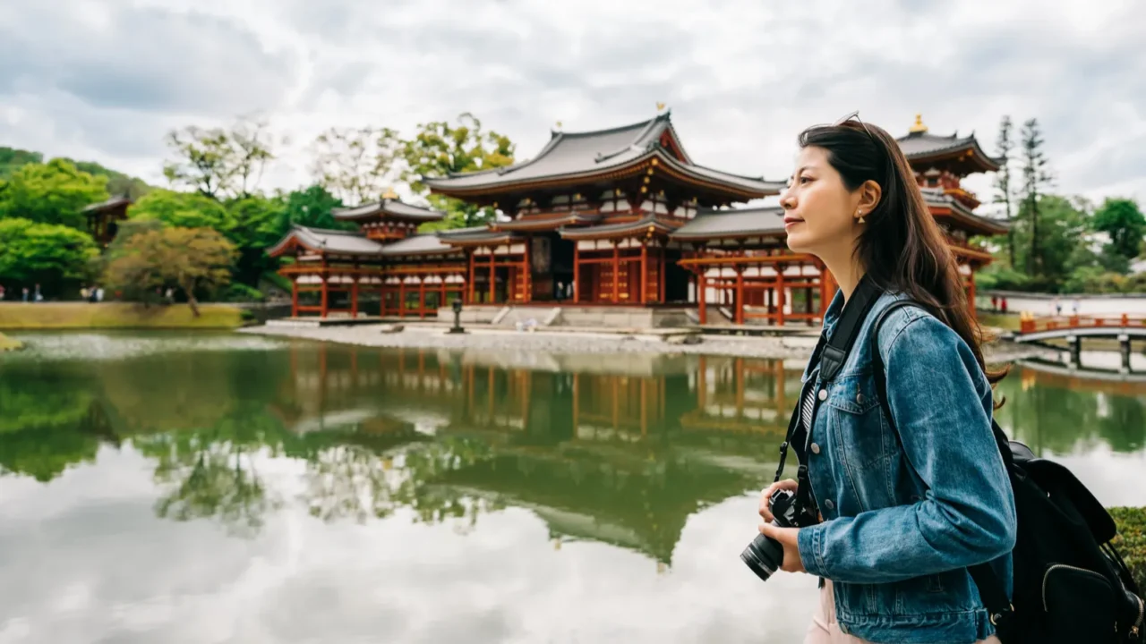 elegant female traveler walking around the pond to the temple