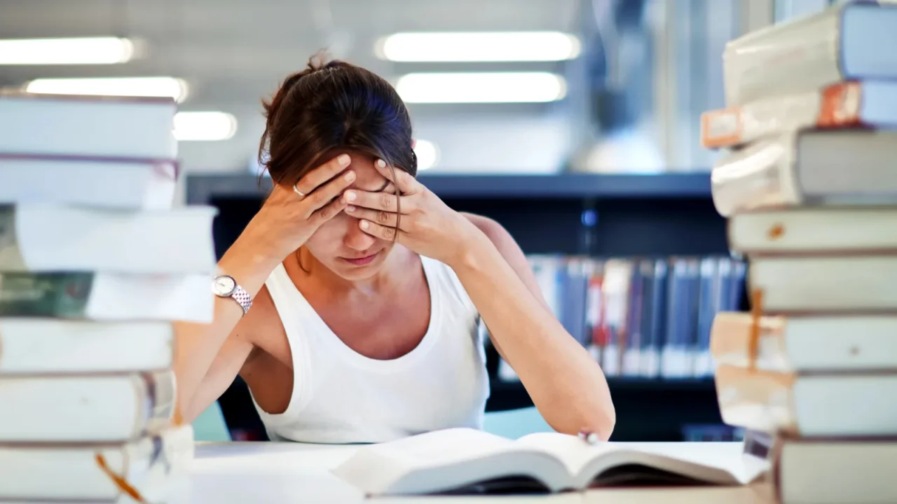 female student sitting with books