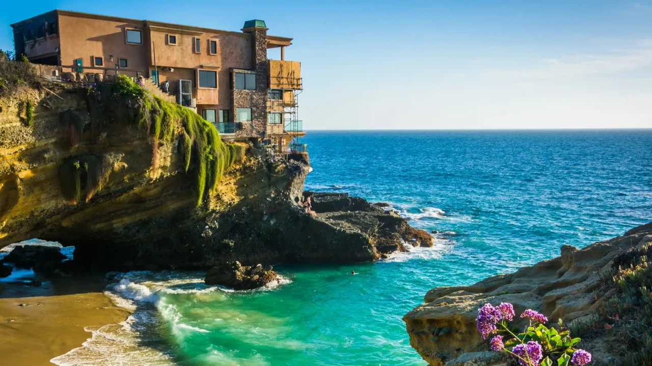 flowers and view of a house on a cliff and