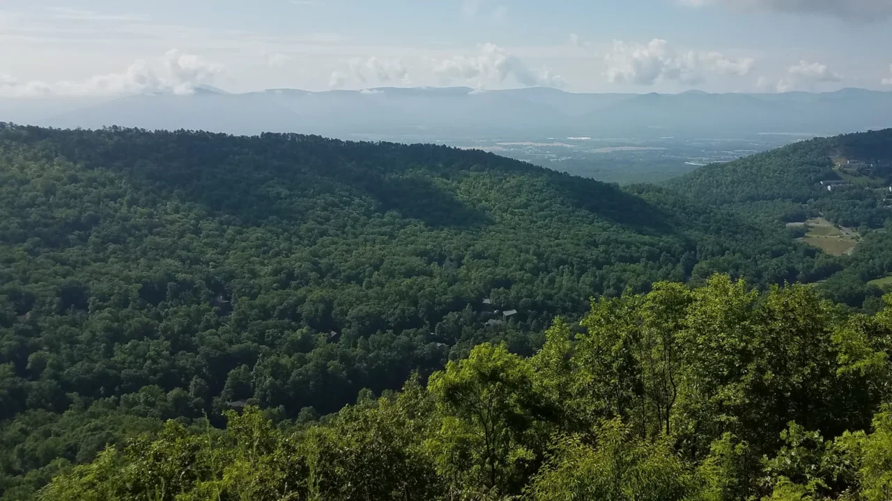 green trees and hills and sky with clouds in massanutten