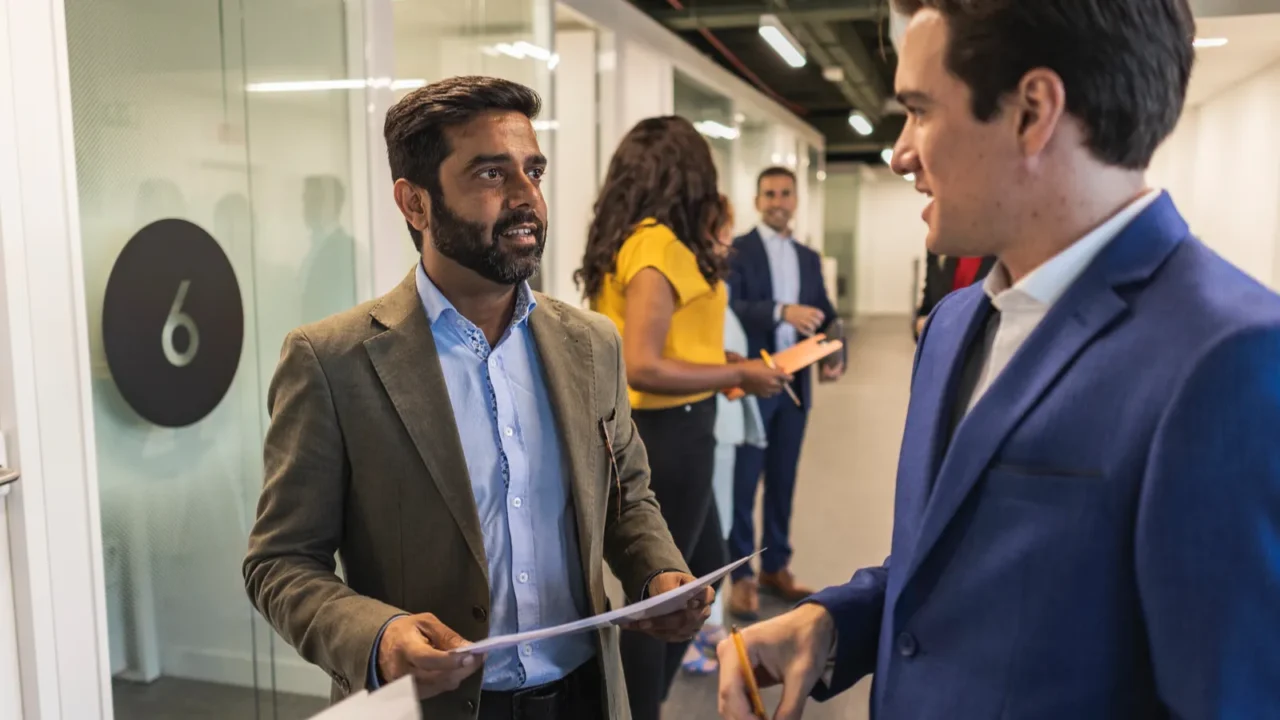 group of multiracial business professionals having a conversation in an