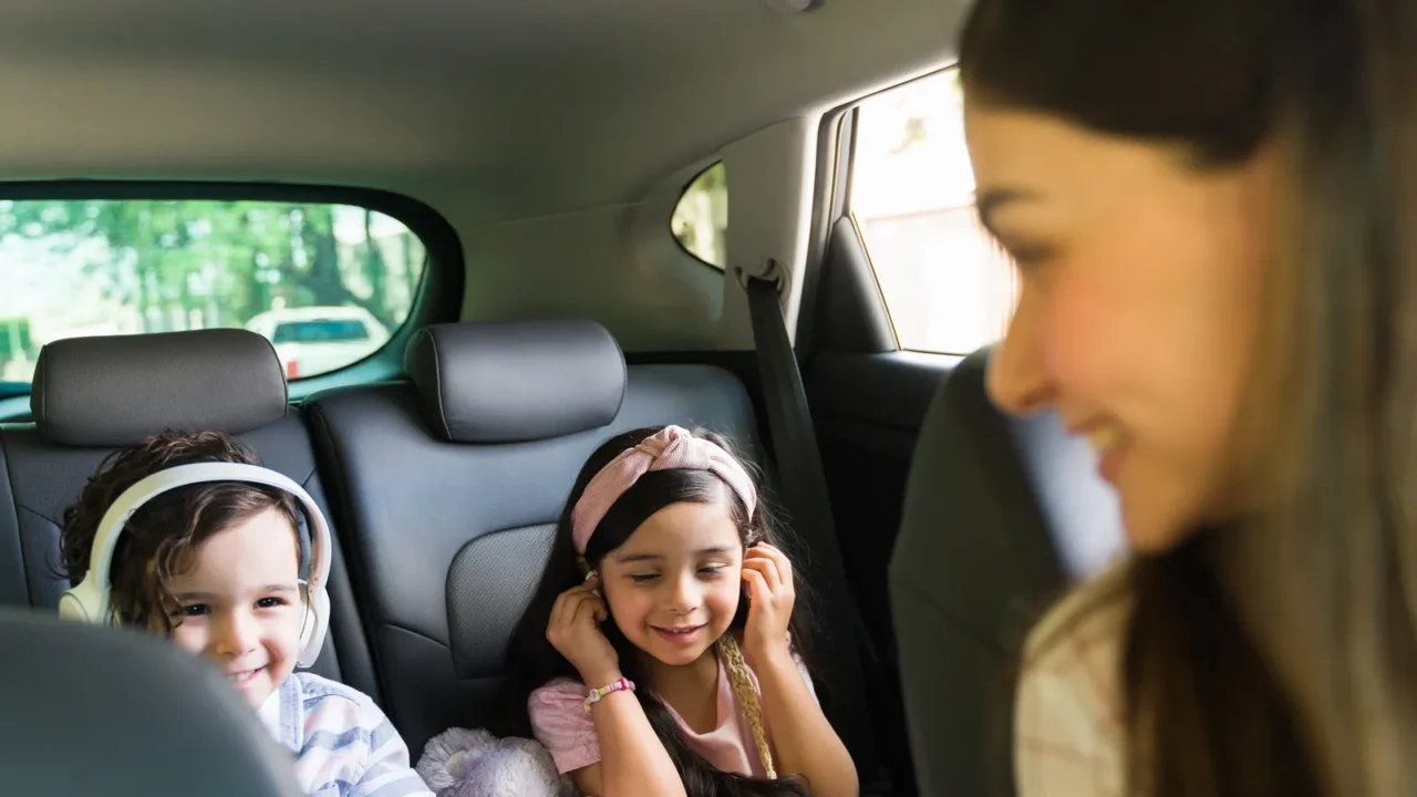 happy little boy and girl with headphones watching a movie
