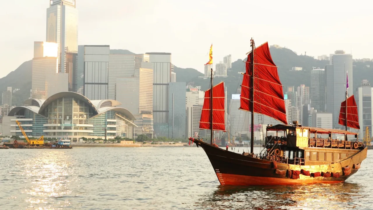 hong kong harbour with tourist junk