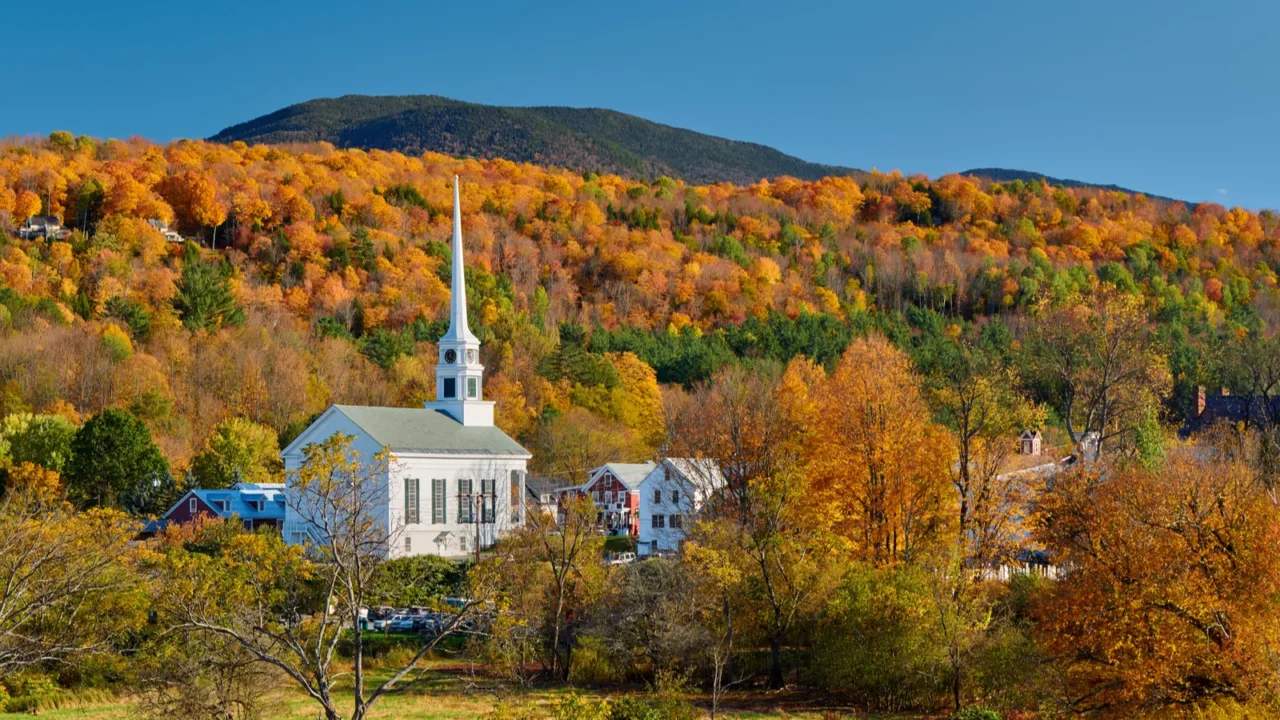iconic new england church in stowe town at autumn