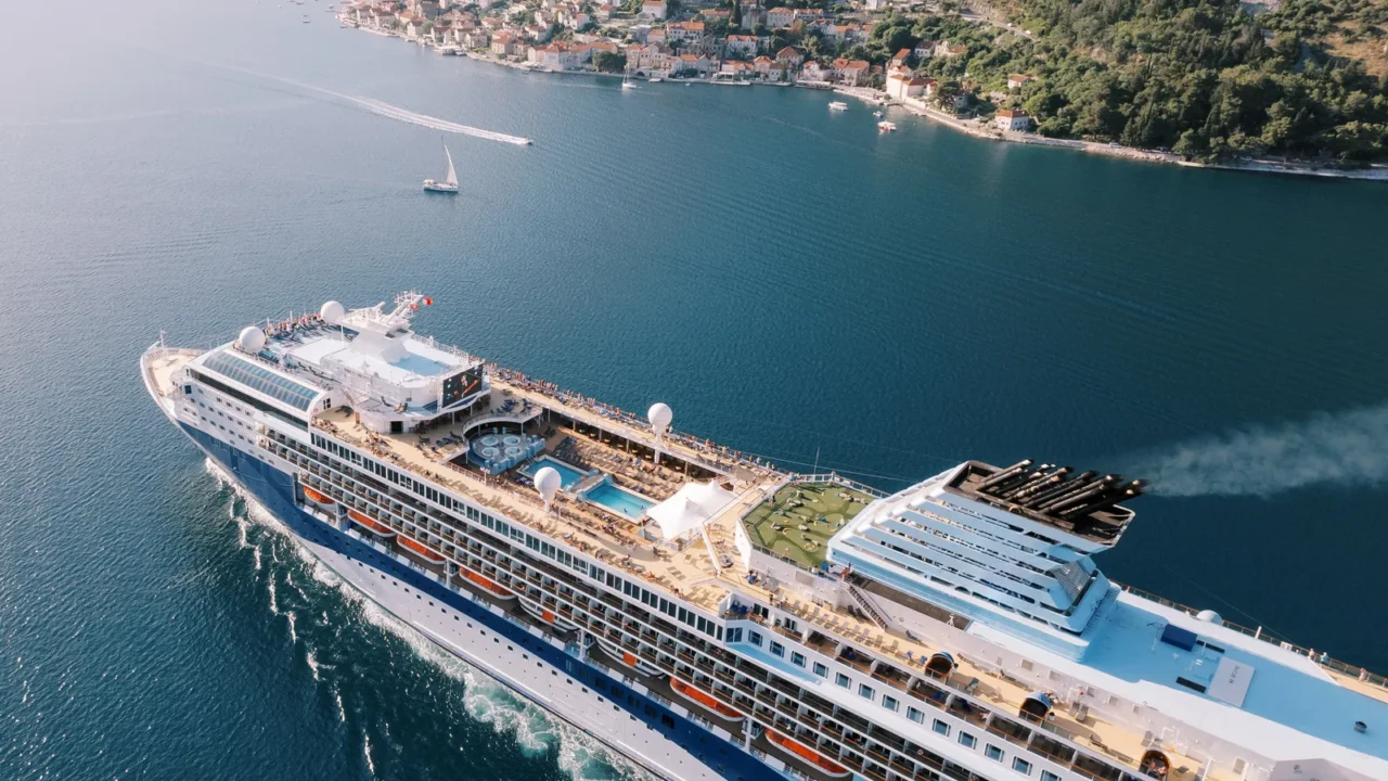 large cruise ship with swimming pools on the deck floats