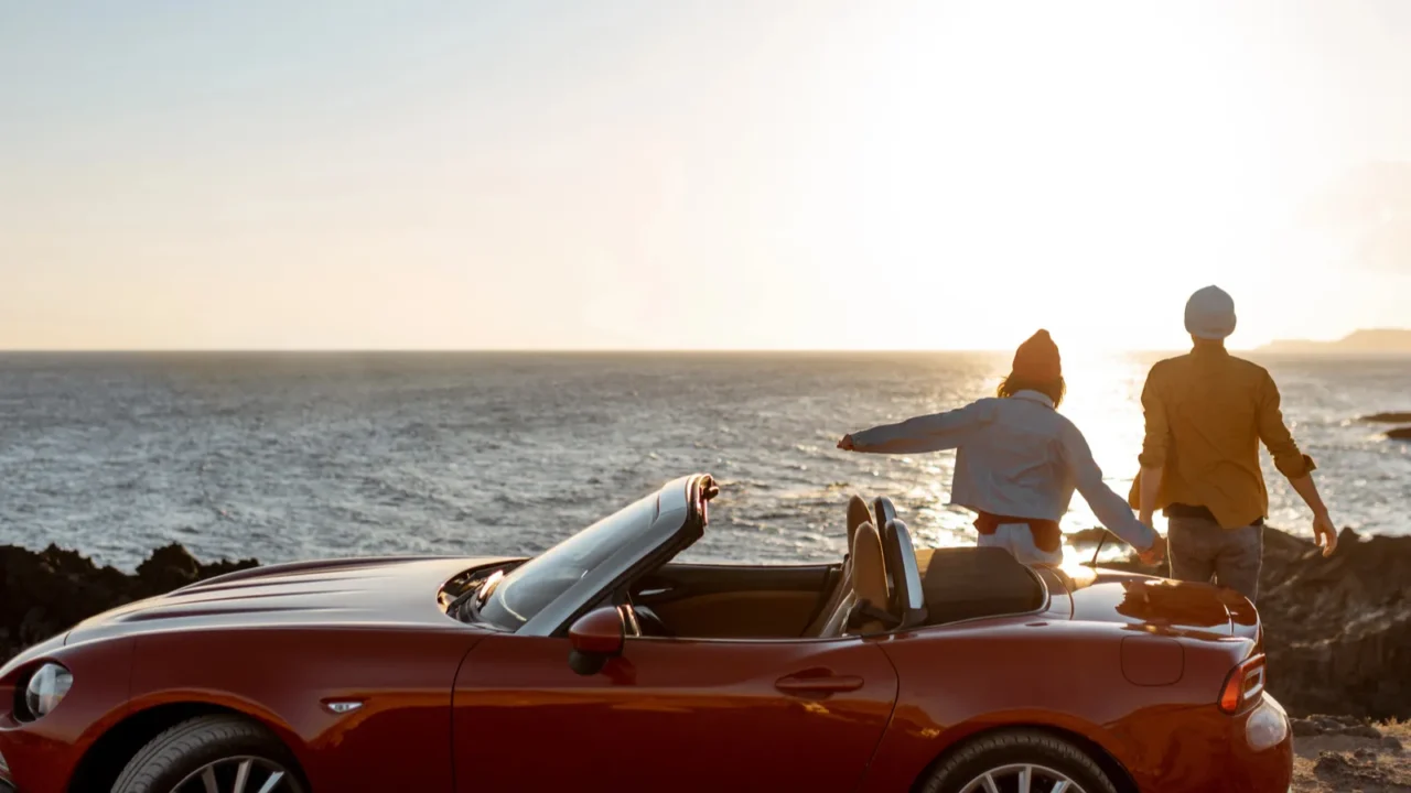 lovely couple on the beach near the car on a
