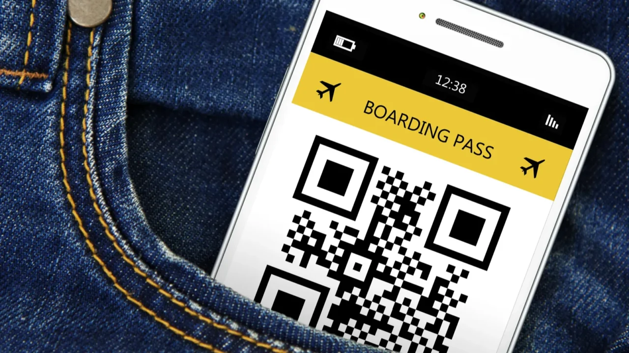 mobile phone with boarding pass in jeans pocket