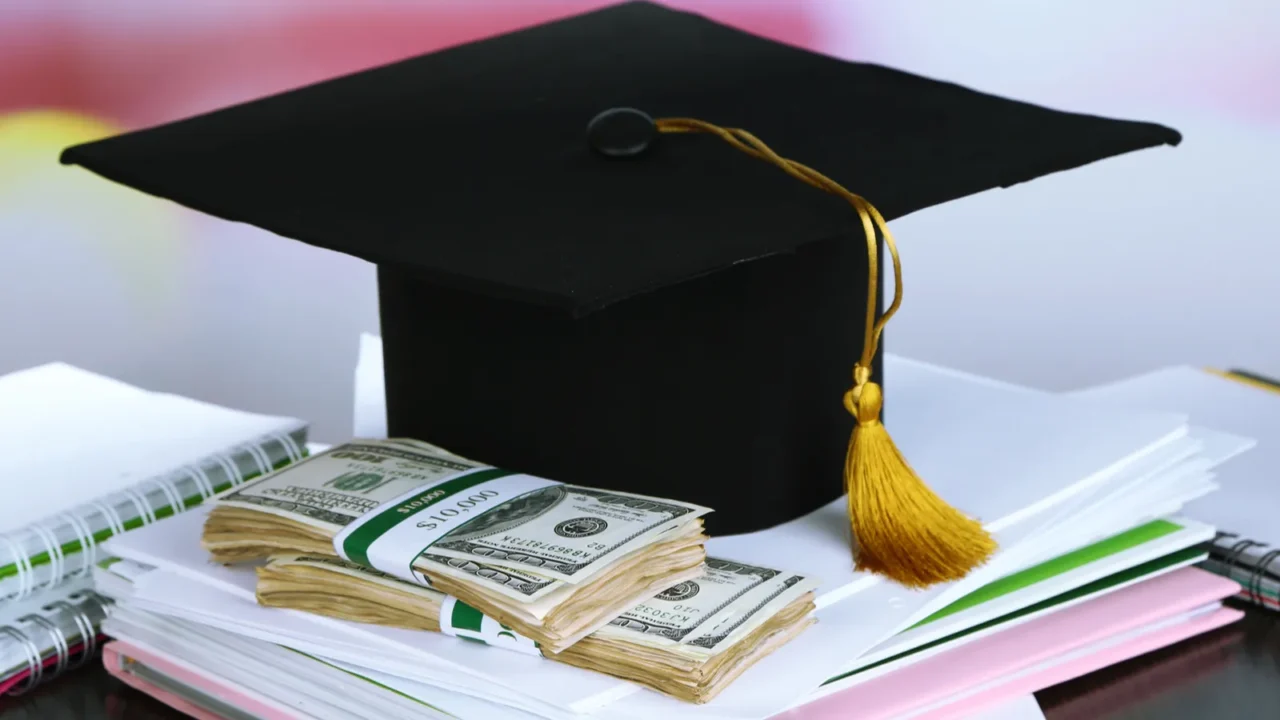 money for graduation or training on wooden table closeup