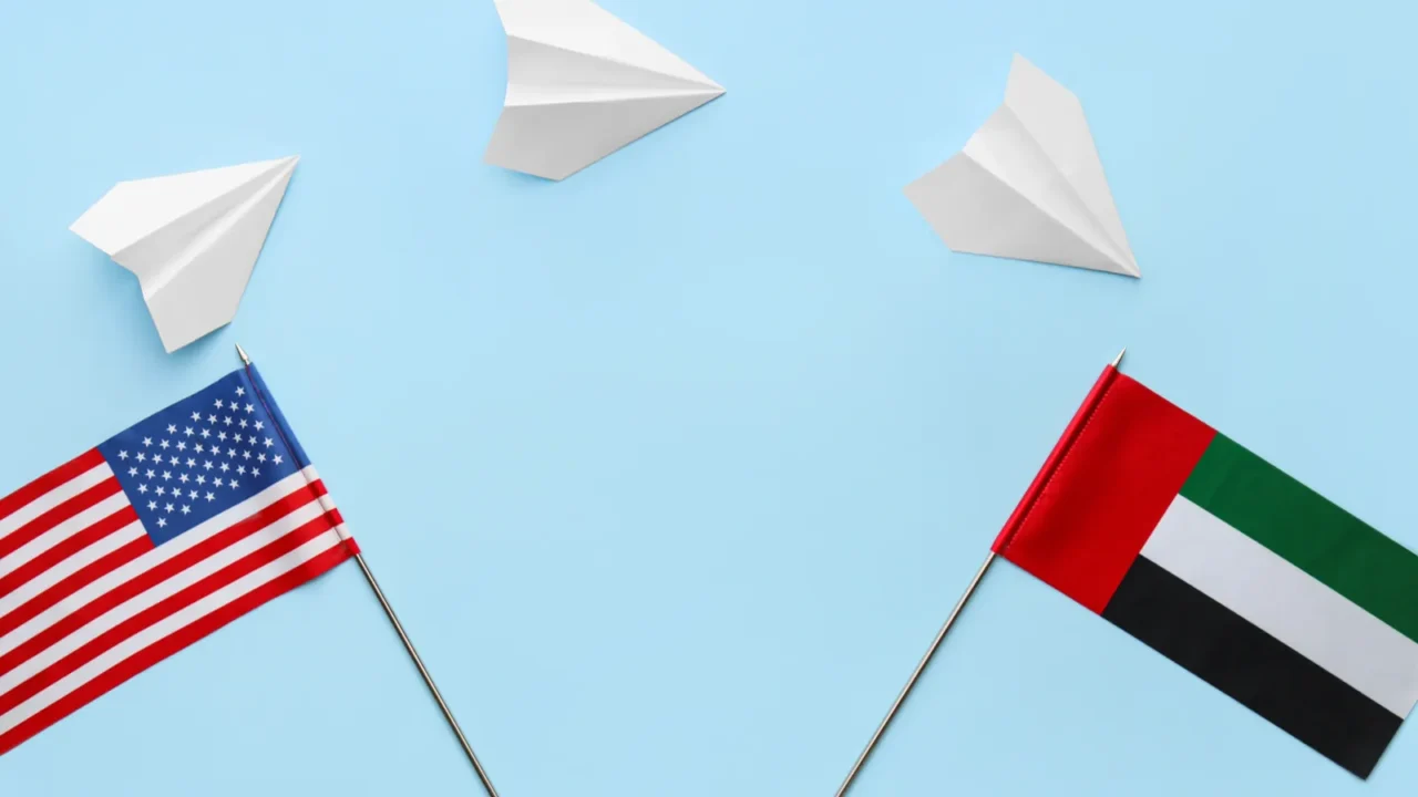 national uae usa flags and paper planes on color background