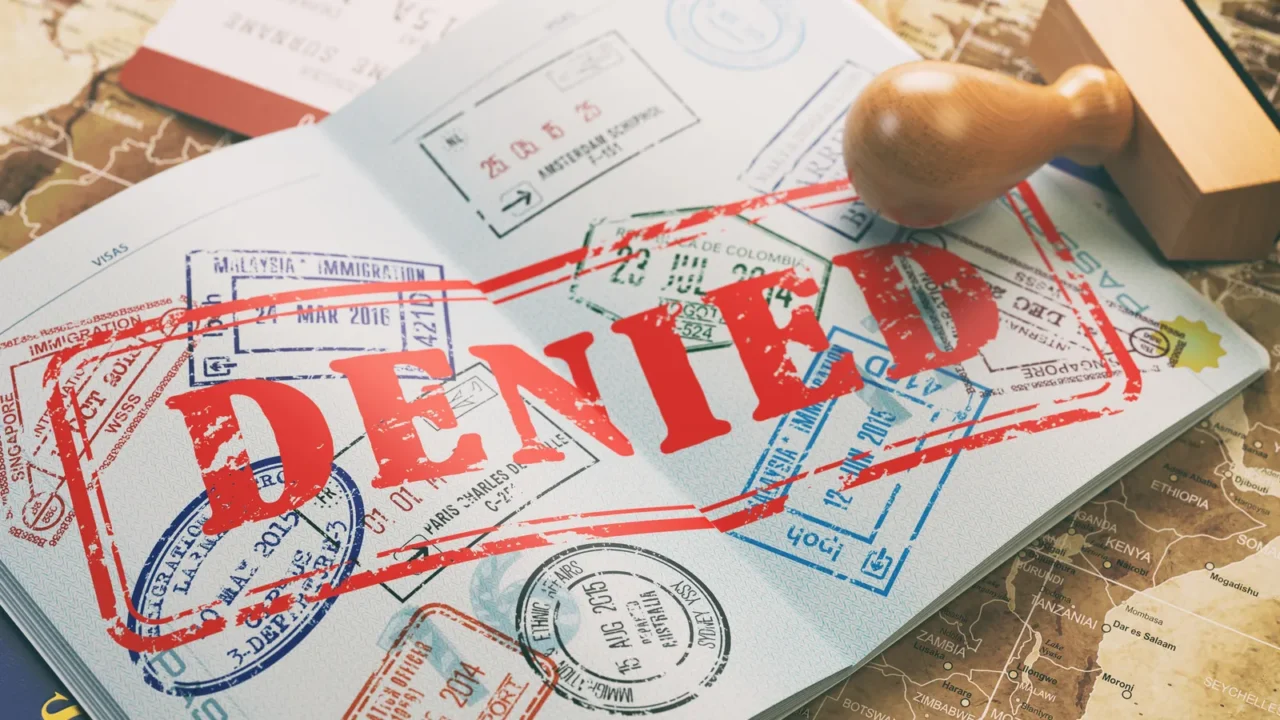passport with denied visa stamp on the map of the