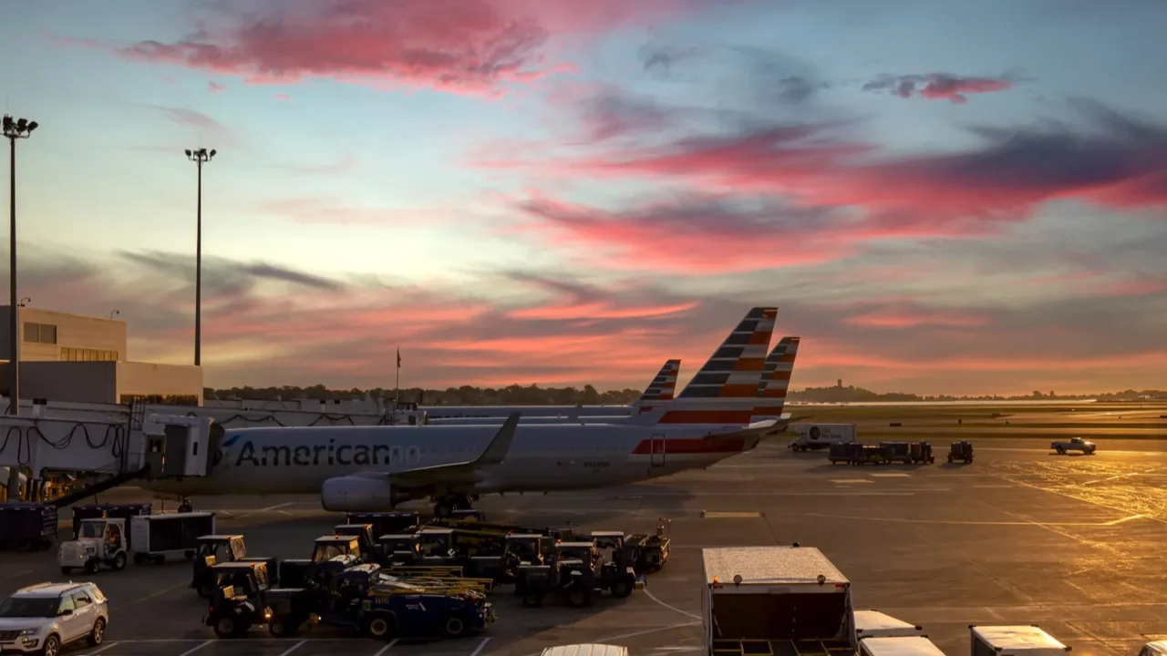 planes departing from boston logan airport at sunset