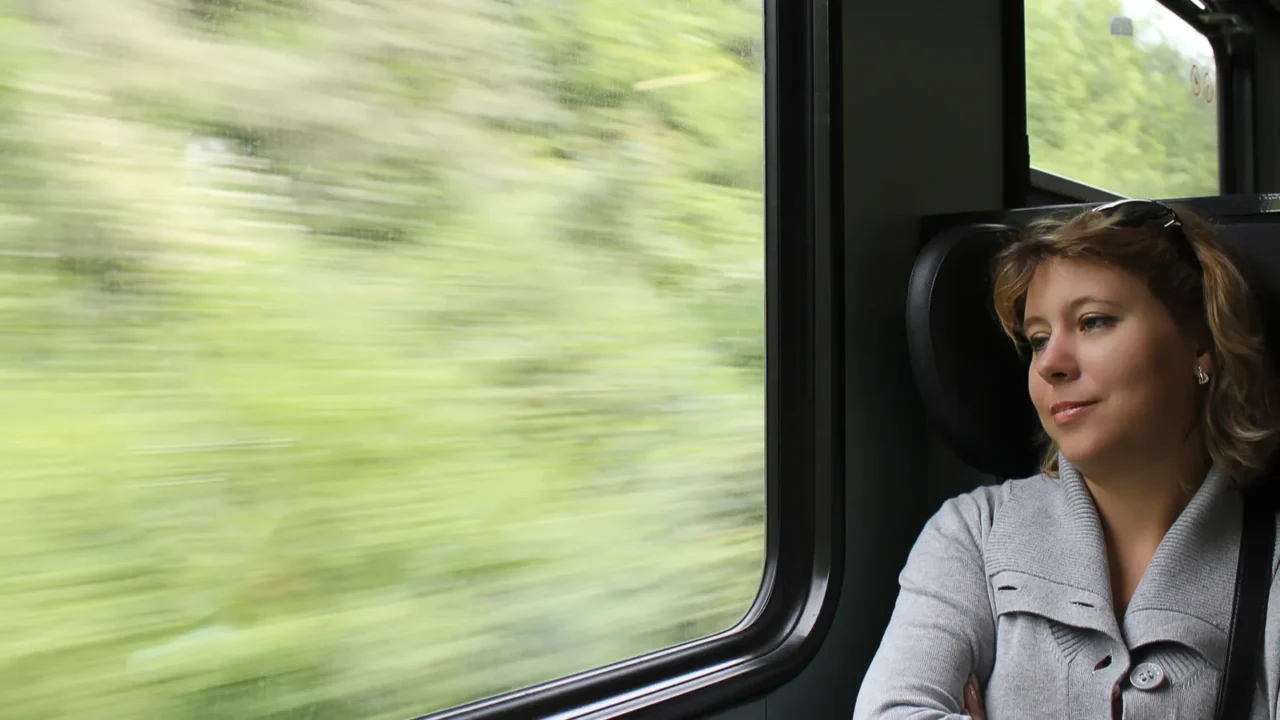 romantic girl looking in the train window