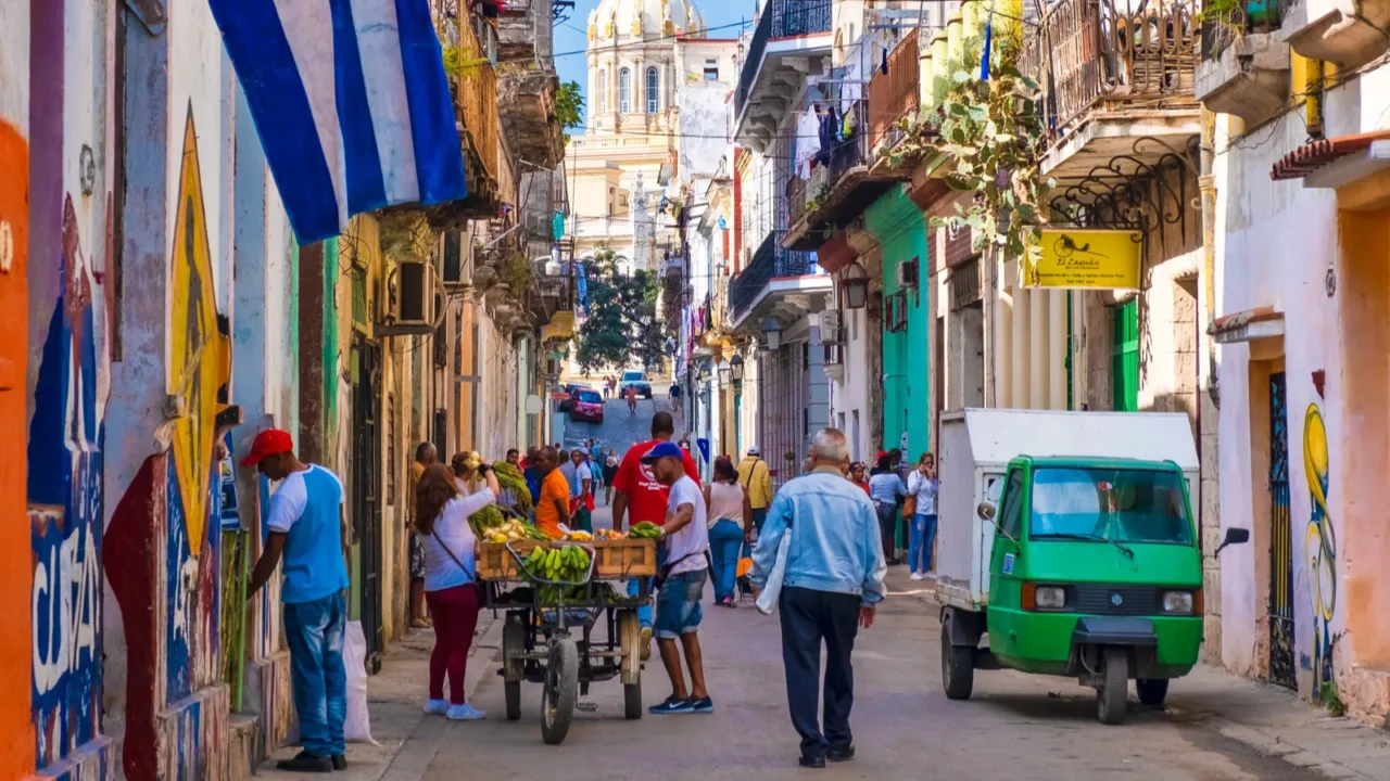 street scene with cuban flag on a colorful street in