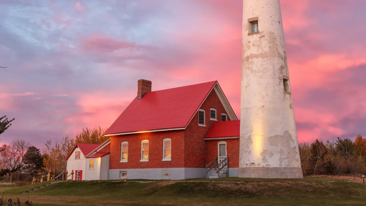 tawas point lighthouse at sunset on michigans lake huron