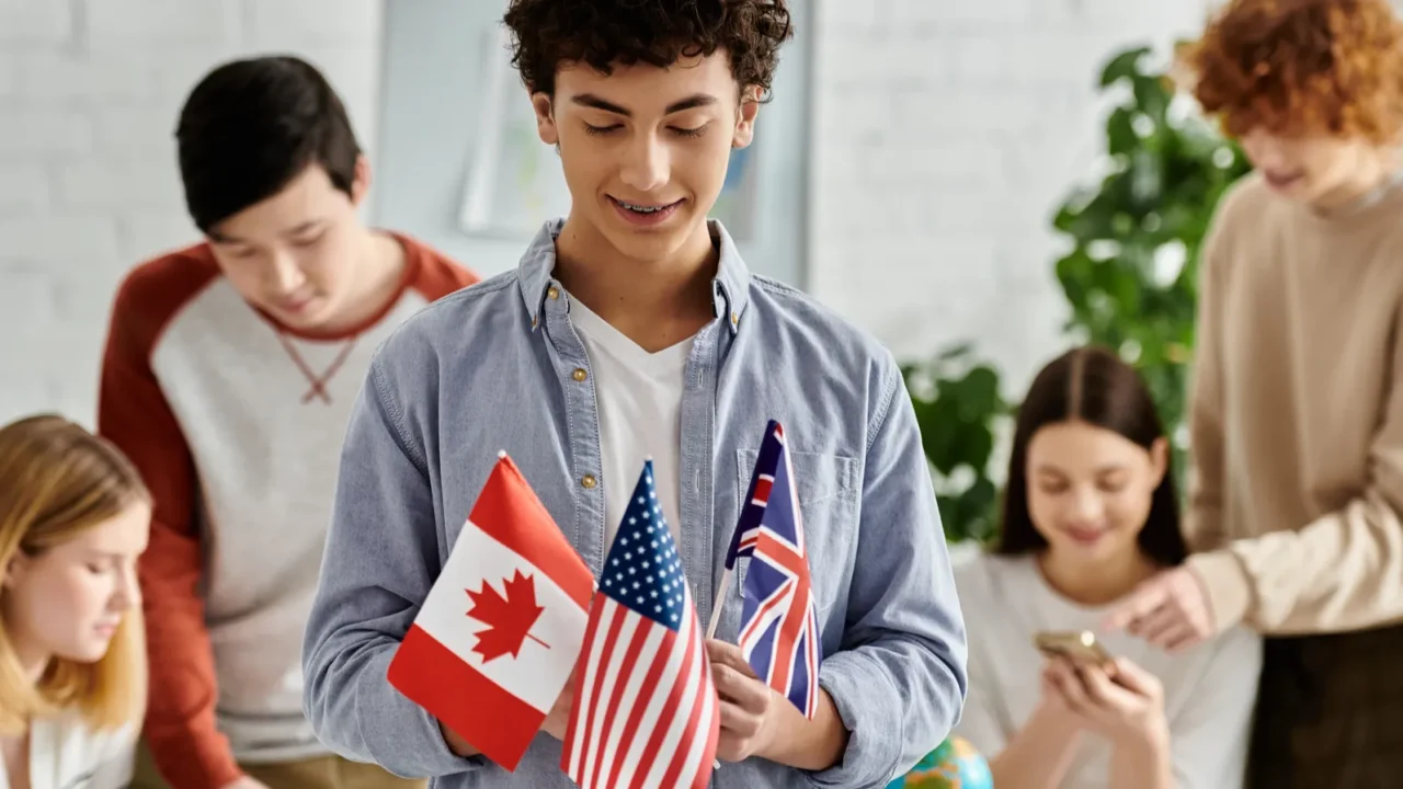 teen holds flags of canada us uk at un model