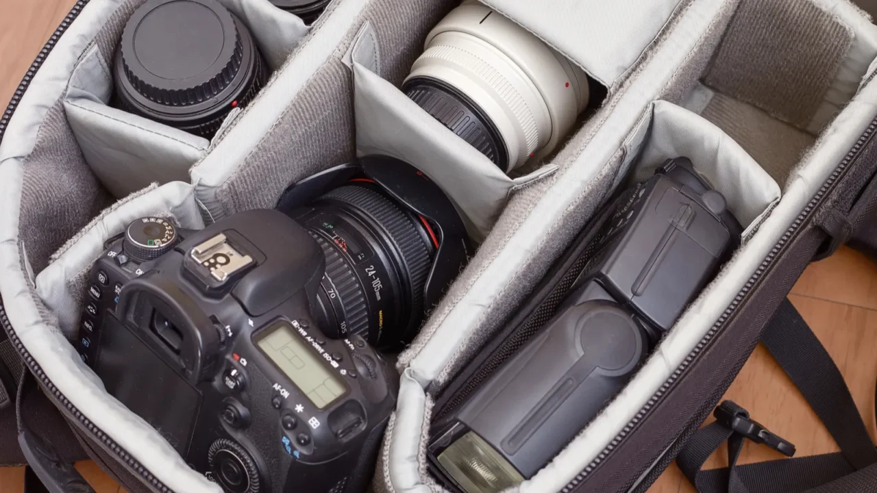the camera with lenses and flash in a backpack