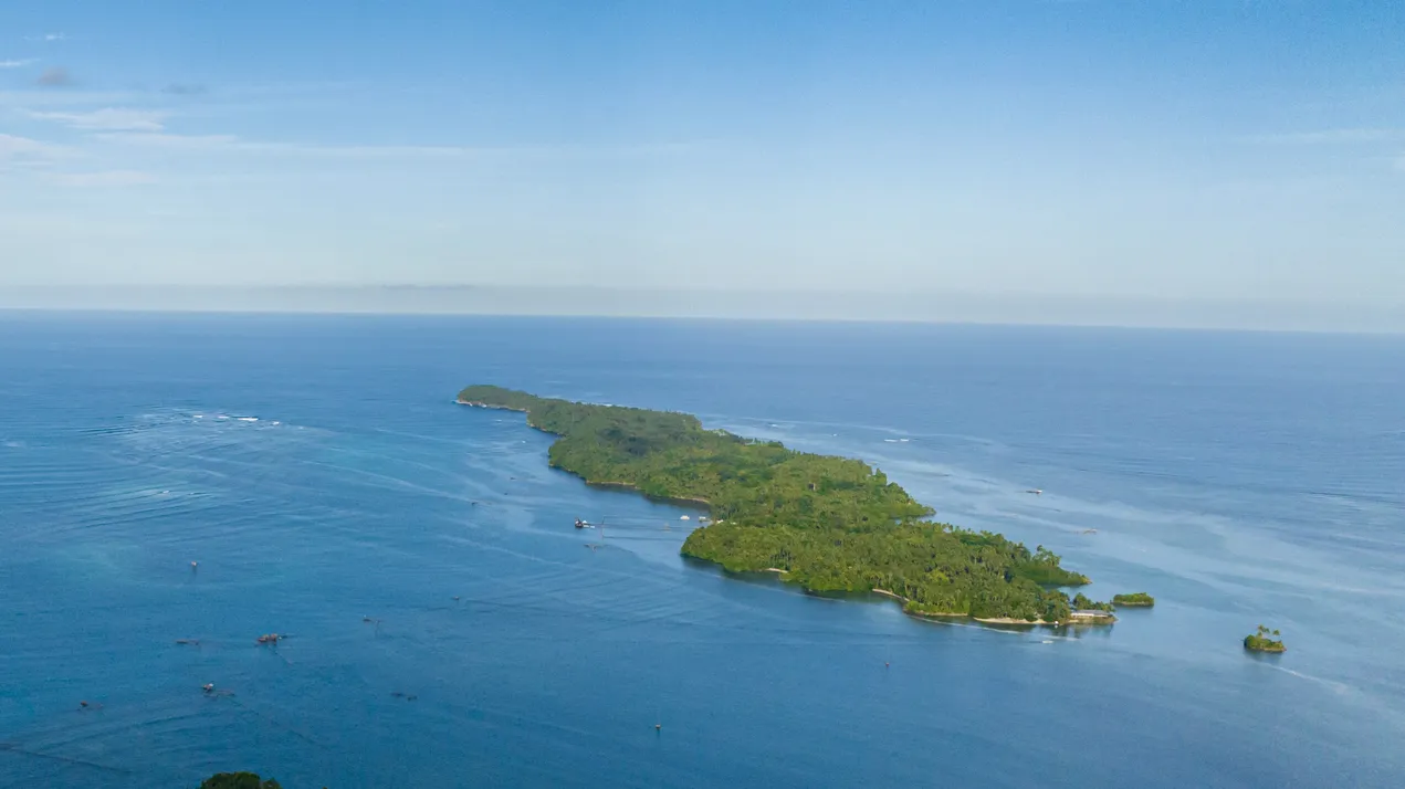 travel concept flying over a beautiful small tropical island seascape