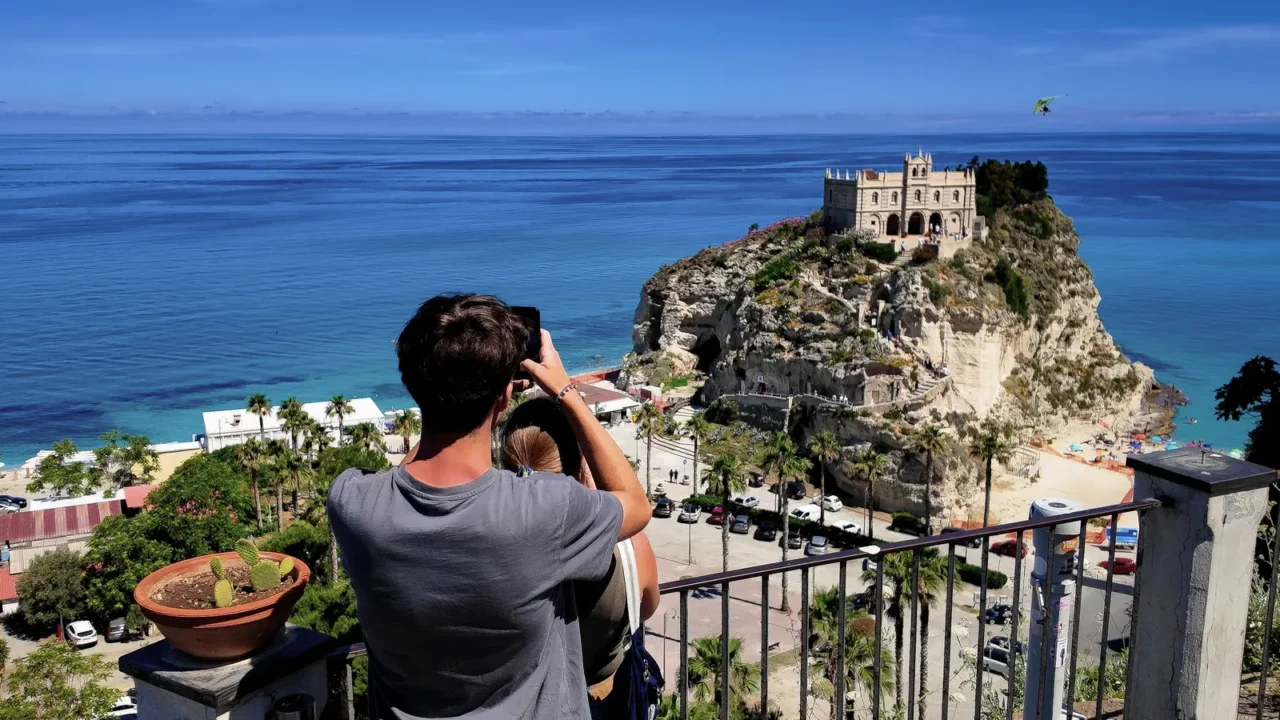 tropea italy  june 2 2025  tourists photographing isola