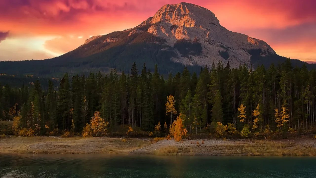 warm sunrise glowing over mountains at barrier lake