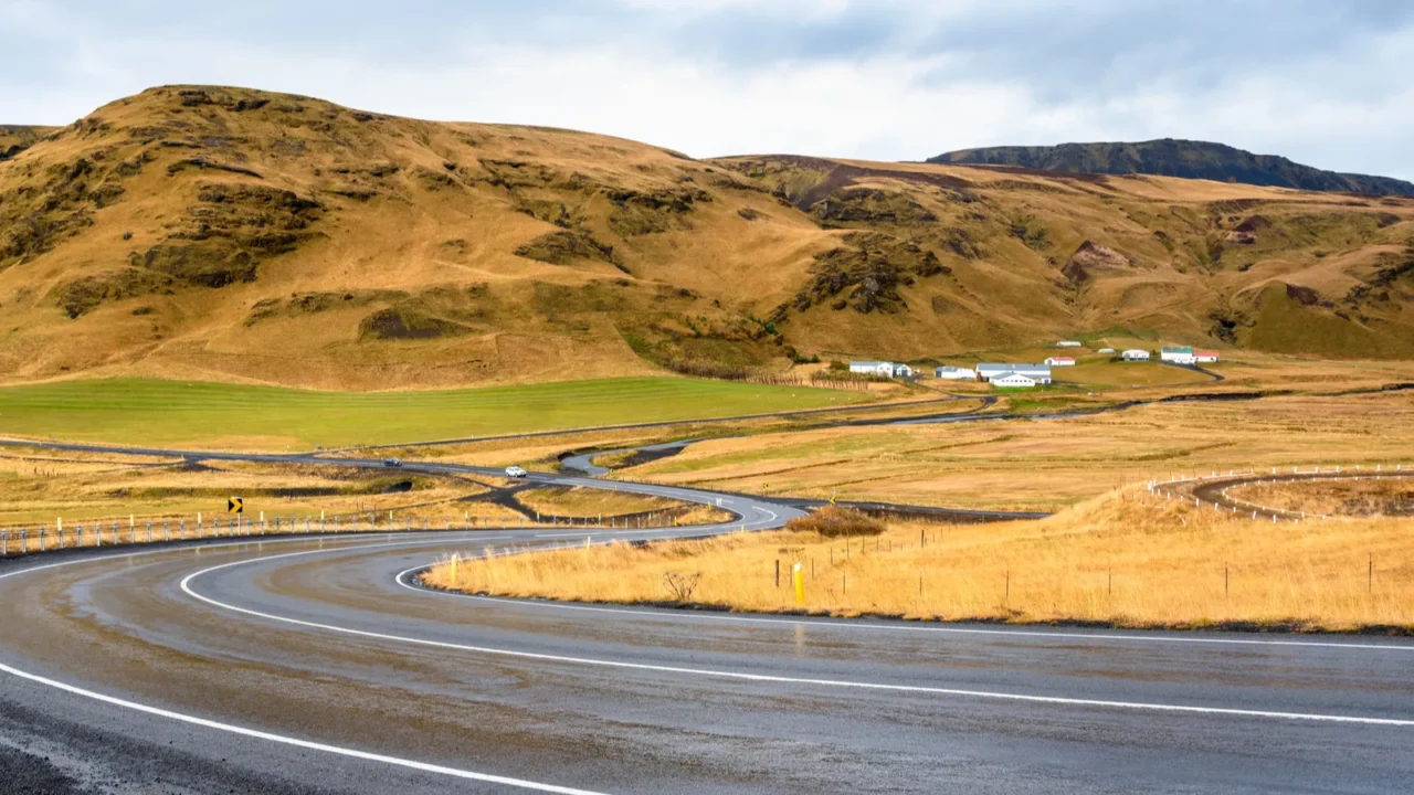 winding wet mountain road in iceland on a cloudy autumn