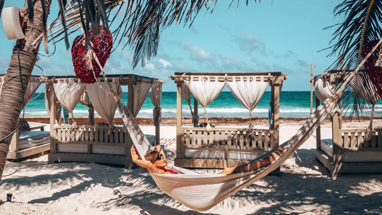 woman relaxing in hammock at beautiful beach resort with hanging