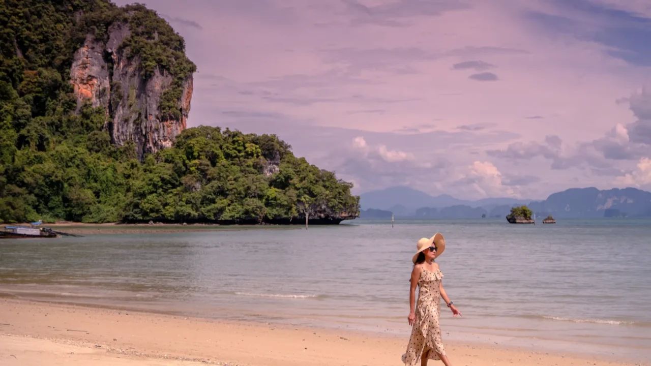 woman walkin on sand beach at koh yao noi island