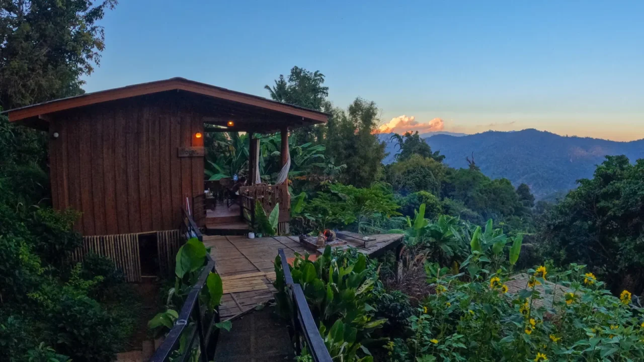 wooden cabin in mountain forest at sunset thailand