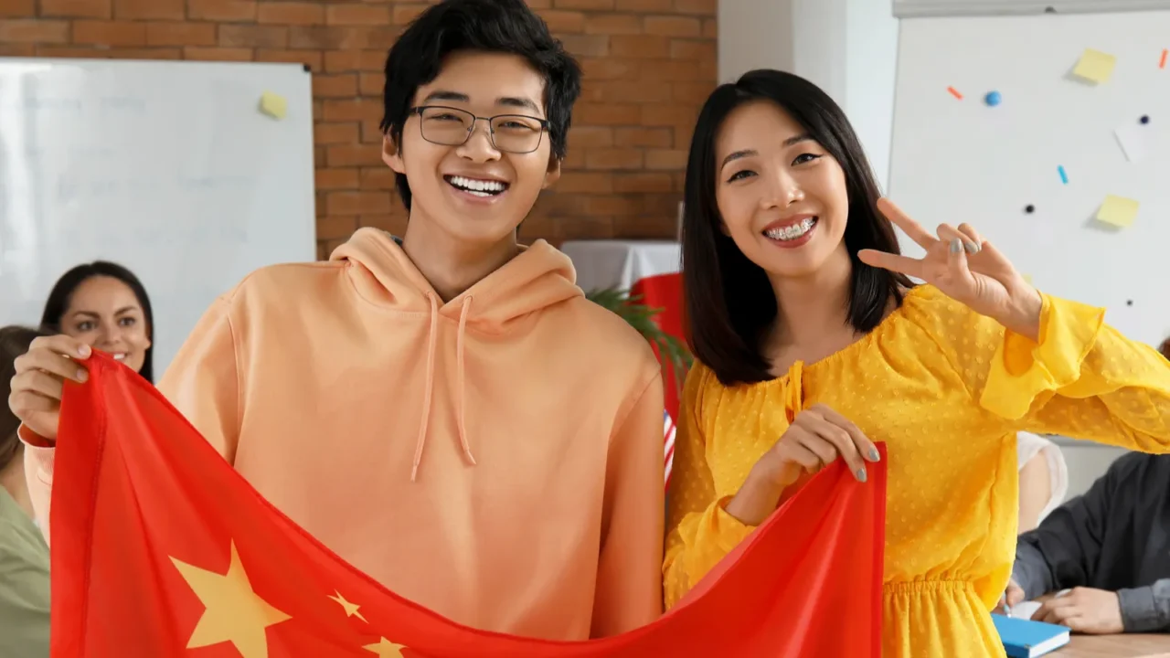 young asian students with chinese flag at language school