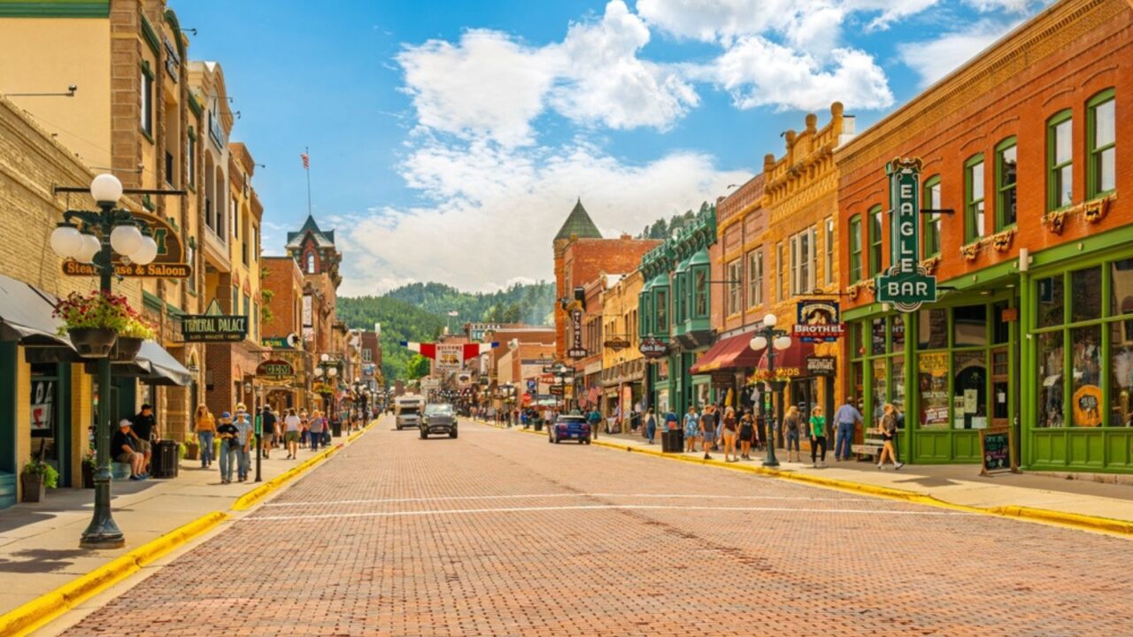 Historic Old West 19th century buildings with saloons, shops and cafes along the brick paved Main Street of Deadwood, in the Black Hills of South Dakota.