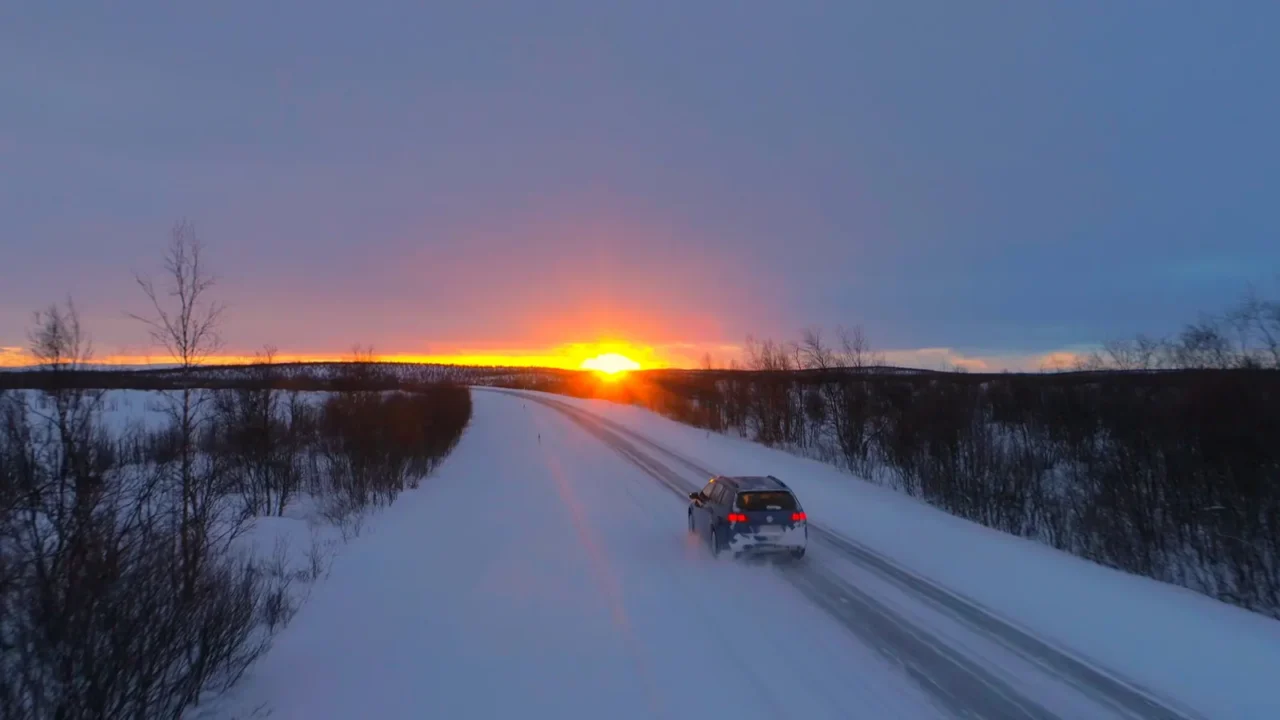aerial lens flare flying behind tourist car speeding through the