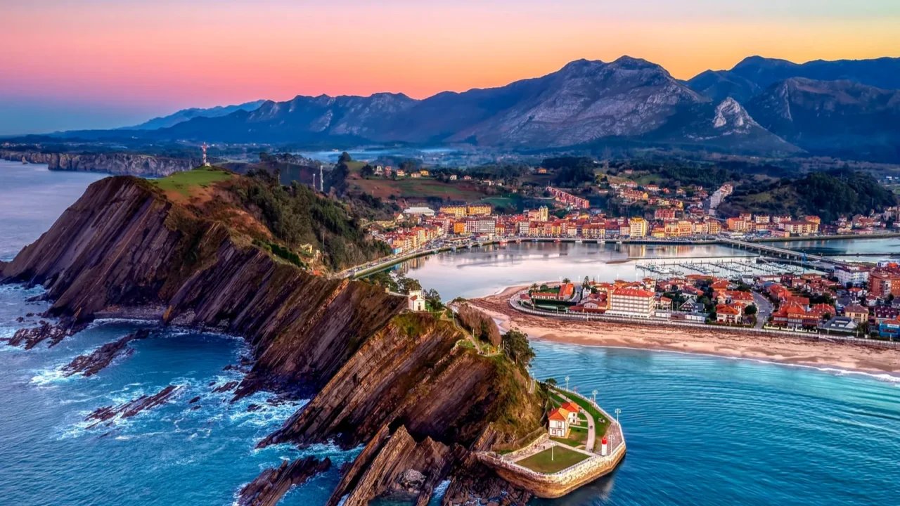 aerial view of ribadesella and its estuary at sunset in