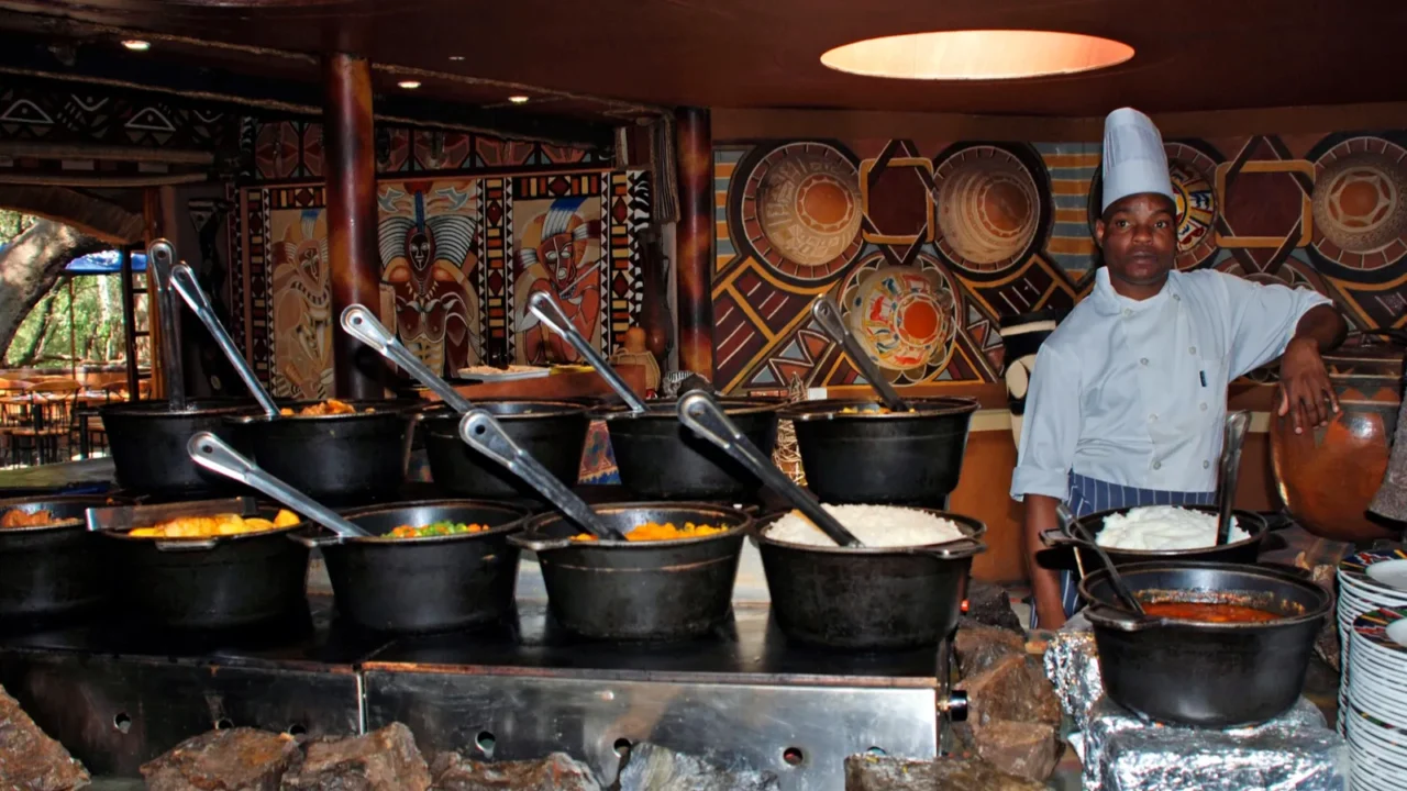 african cook in tribal restaurant south africa