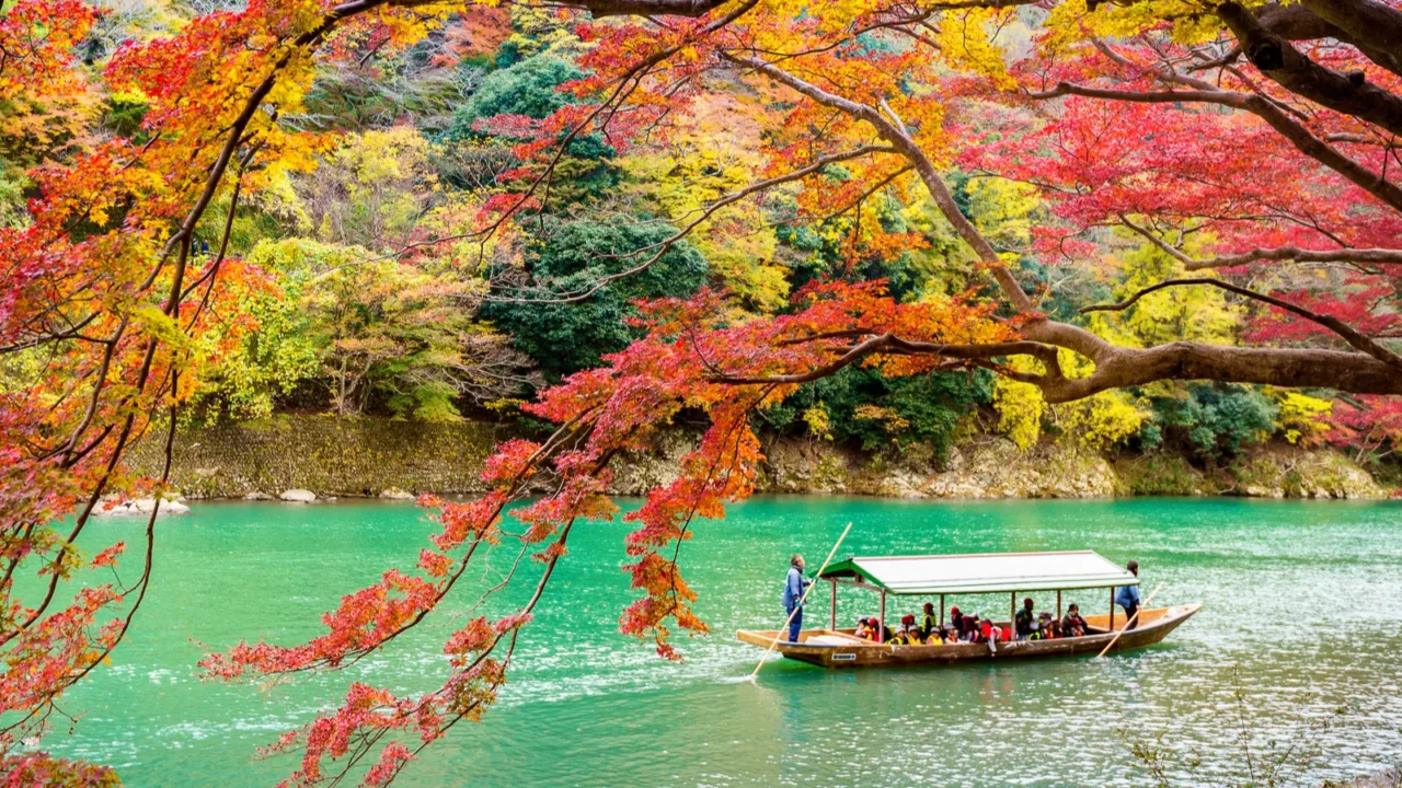 Arashiyama in autumn season along the river in Kyoto, Japan. — Photo by