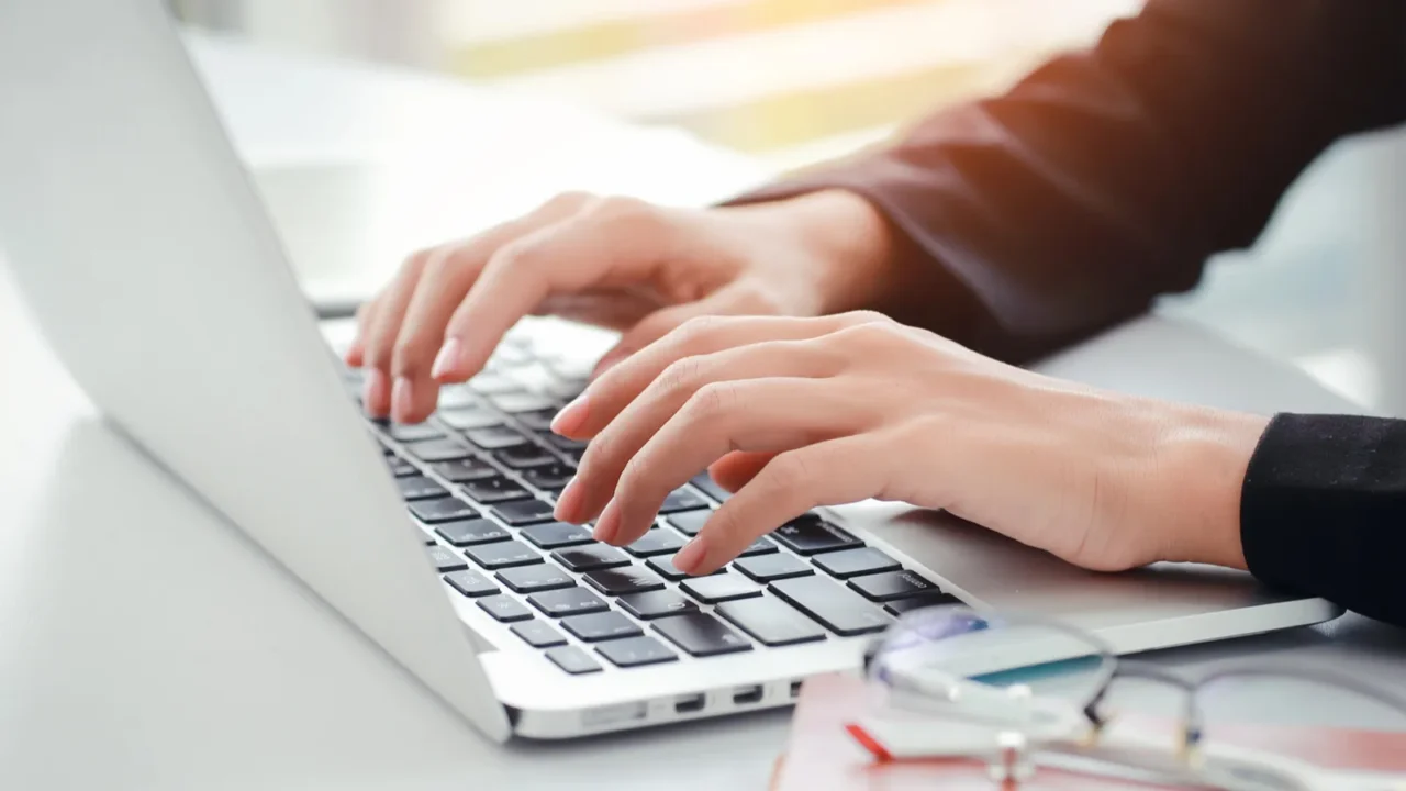 businesswoman hands with glasses using computer
