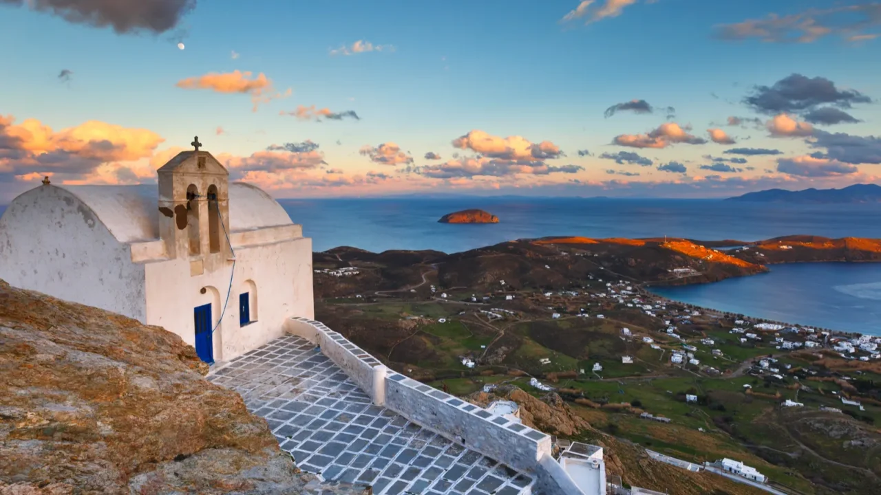 View of the harbor, Livadi village and Sifnos island in the distance from Chora, Serifos island in Greece.