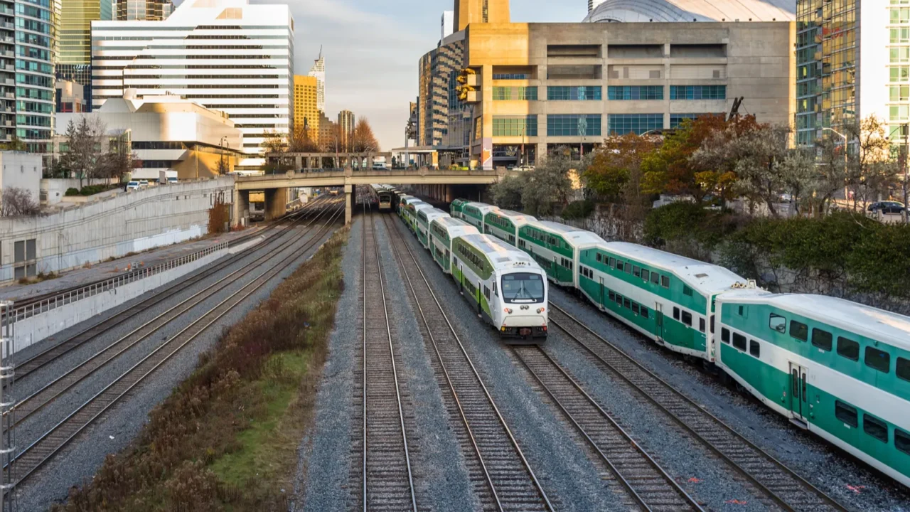 commuter trains approaching a station on a sunny winter