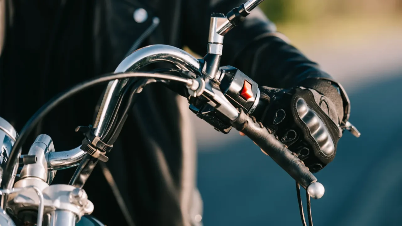 cropped view of biker sitting on classic motorcycle