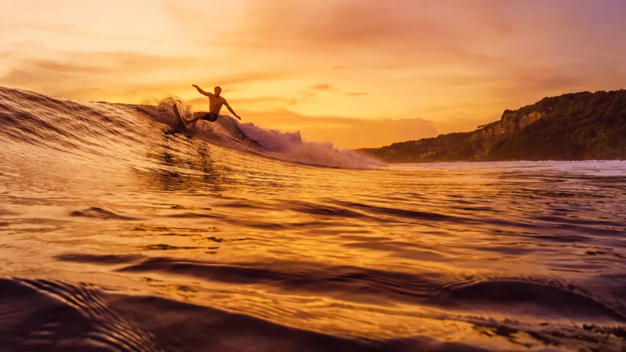 december 14 2022 bali indonesia man during surfing with sunset