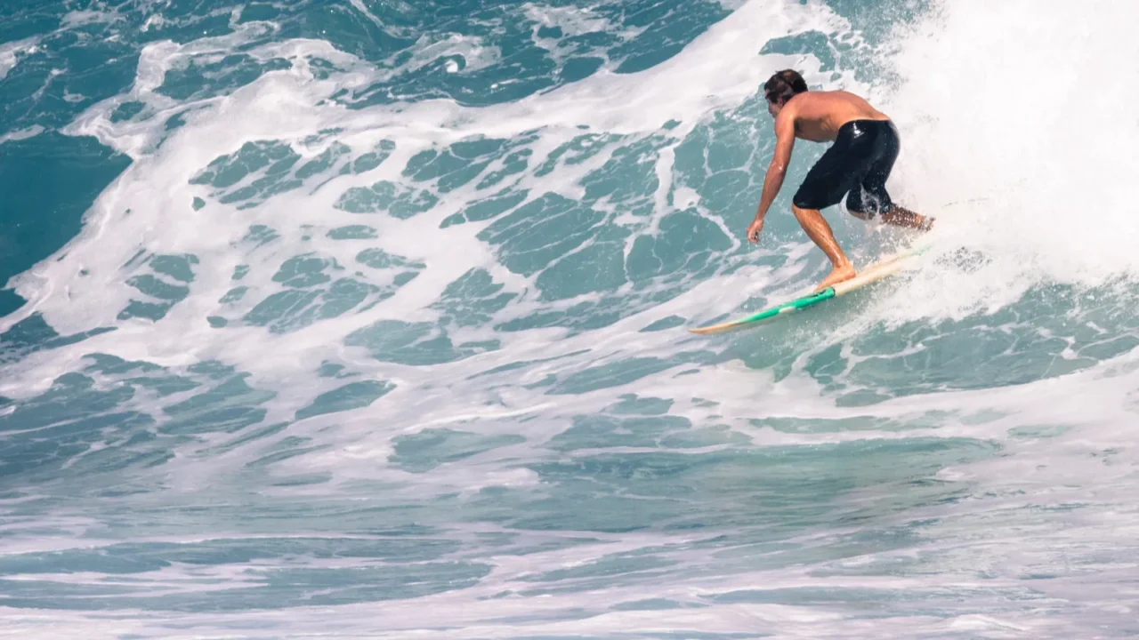 extreme surfer riding giant ocean wave in hawaii
